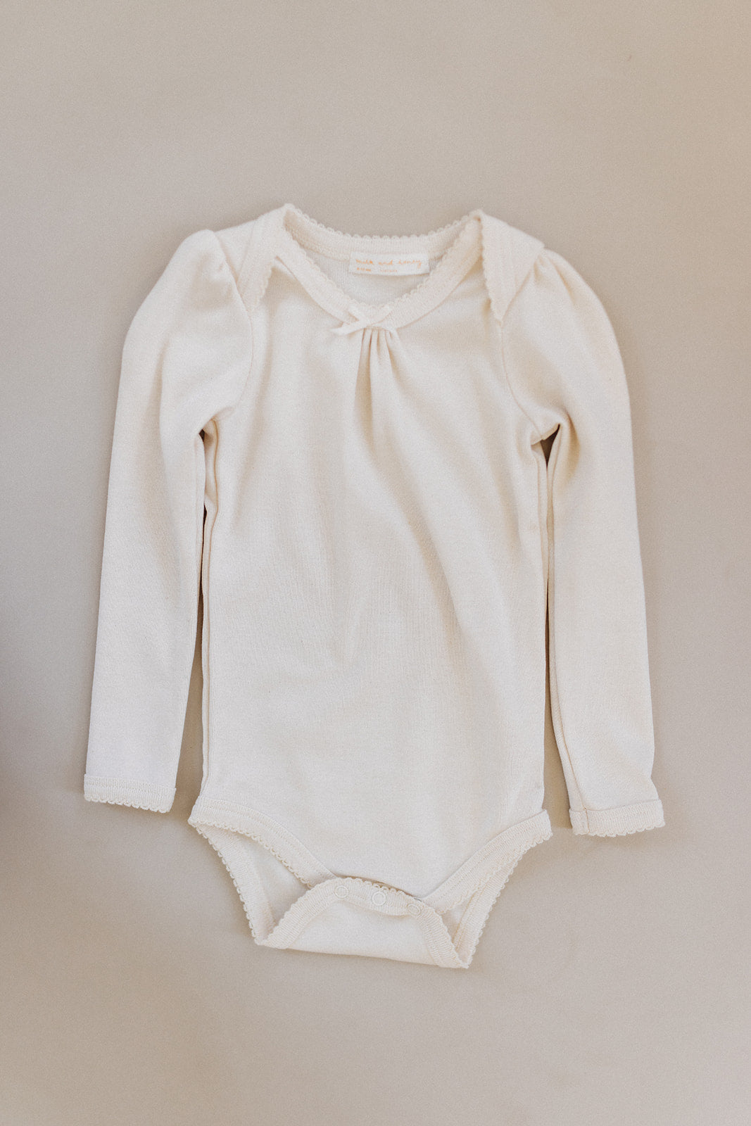 Load image into Gallery viewer, long sleeve pouf onesie, milk
